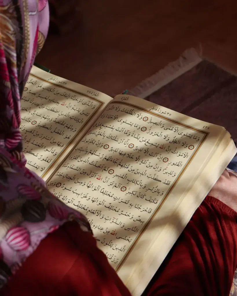 Woman in a headscarf reading the Quran